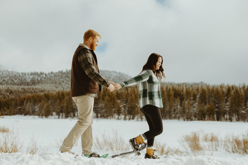 wife leading her husband across the snowy Lake Tahoe hike